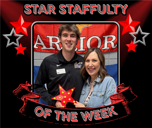 A tall man and a woman with long dark hair pose with the red star award.
